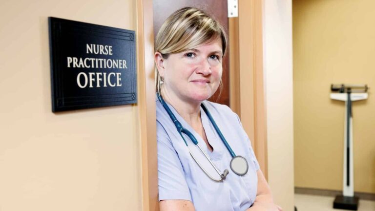 Nurse practitioner standing outside her private practice office